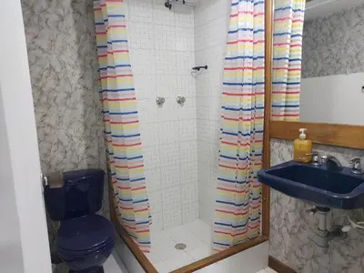 a bathroom with a shower with a toilet and a sink at Loft Poblado Park in Medellín