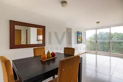 a dining room with a table and chairs and a mirror at Furnished apartments for rent in Medellín