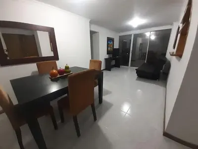 a living room with a dining room table and chairs at Furnished apartments for rent in Medellín