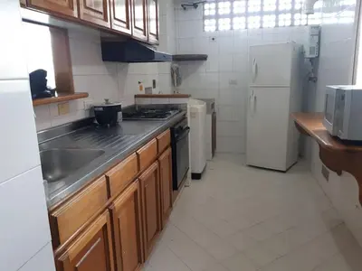 a kitchen with a sink and a stove and a refrigerator at Furnished apartments for rent in Medellín