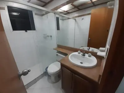 a bathroom with a sink and a toilet and a mirror at Furnished apartments for rent in Medellín