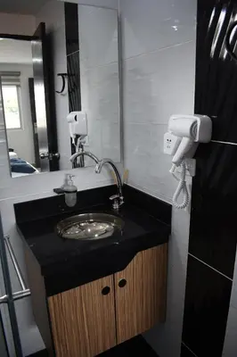 a bathroom with a sink and a mirror at Hostel Boutique Nido de Loros in Medellín
