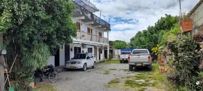 a white truck parked in front of a building at La Orquidea in Mariquita