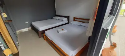 a small room with two beds in a room at La Orquidea in Mariquita