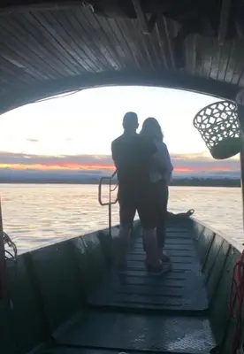 a man and a woman standing on the front of a boat at CASA DEL PARQUE Hotel, en Puerto Perales, corregimiento de Puerto triunfo 30 min del parque Nápoles in Puerto Perales