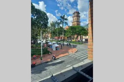 a view from a window of a street with a clock tower at Apartamento en Parque del Poblado in Medellín