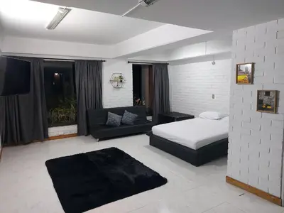 a living room with a bed and a couch at Apartamento en Parque del Poblado in Medellín