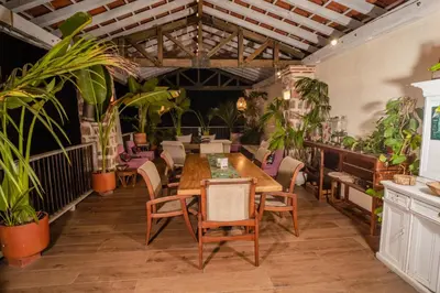 a dining room with a table and some plants at Casa Al Alma in Santa Fe de Antioquia