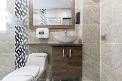 a bathroom with a toilet and a sink at Hotel Velero in San Antonio de Pereira