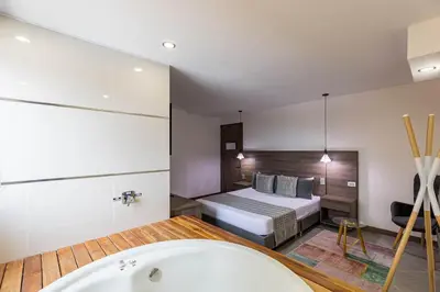 a bathroom with a bed and a bath tub at Hotel Velero in San Antonio de Pereira