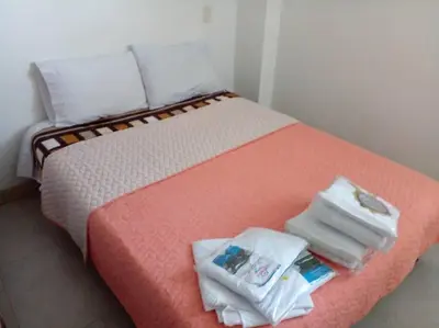 a bed with towels and towels on top of it at Casa De Campo in Santuario