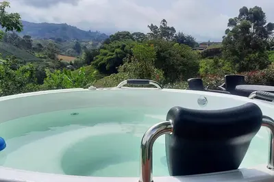 a jacuzzi tub with a view of a mountain at Casa De Campo in Santuario