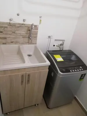 a kitchen with a sink and a sink and a stove at Apartamento La Ceja in La Ceja