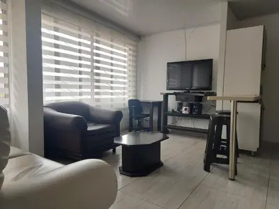 a living room with a couch and a flat screen tv at Apartaestudio3 Sector Cable-Estadio Mejor Ubicacion de Manizales in Manizales
