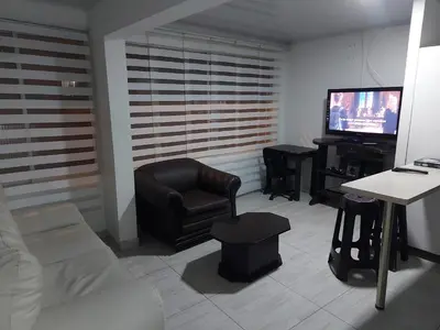a living room with a couch and a television at Apartaestudio3 Sector Cable-Estadio Mejor Ubicacion de Manizales in Manizales