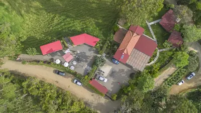 an overhead view of a house with parked cars at Gulupa Ecolodge in Jardin