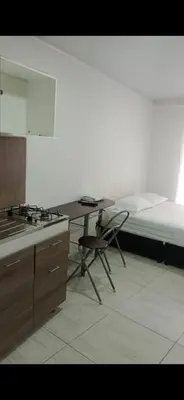 a kitchen with a bed and a table and a desk at Apartaestudio6 sector Cable Estadio in Manizales