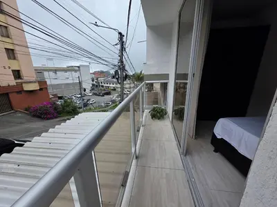 a balcony with stairs and a bed on a building at Apartaestudio6 sector Cable Estadio in Manizales