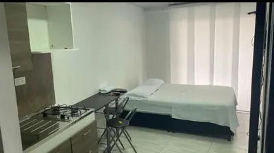 a small kitchen with a bed in a room at Apartaestudio6 sector Cable Estadio in Manizales