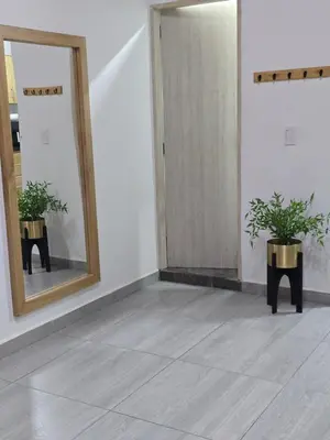 a hallway with a mirror and two potted plants at Apartamento Guatapé Plaza in Guatapé