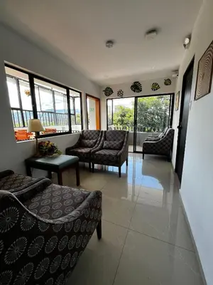 a living room with couches and chairs and windows at Balcón Paisa SAS in Medellín
