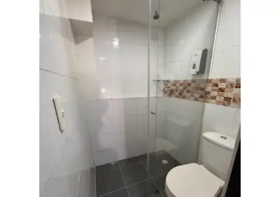 a white bathroom with a toilet and a shower at Balcón Paisa SAS in Medellín