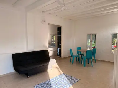 a living room with a couch and a table and chairs at Cabaña Doradal MILOS in Puerto Triunfo