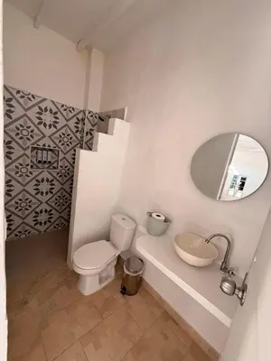 a bathroom with a toilet and a sink and a mirror at Cabaña Doradal MILOS in Puerto Triunfo