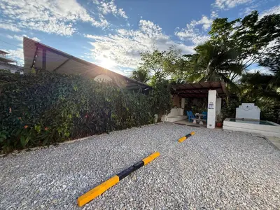 two baseball bats on the gravel in front of a building at Cabaña Doradal MILOS in Puerto Triunfo