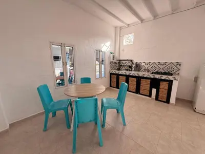 a dining room with a table and four chairs at Cabaña Doradal MILOS in Puerto Triunfo