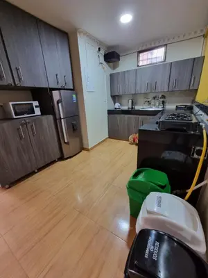 a kitchen with wooden cabinets and a wooden floor at HOSPEDAJE EN ESPLENDOR in Jardin