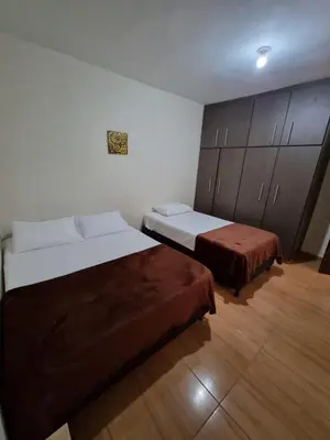 a hotel room with two beds and cabinets at HOSPEDAJE EN ESPLENDOR in Jardin