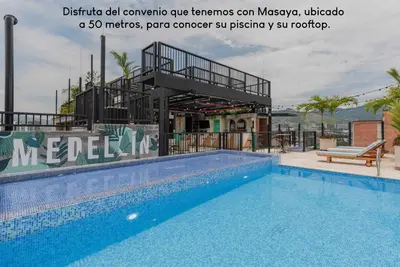 a large swimming pool next to a building at Poblado Park Guest House in Medellín