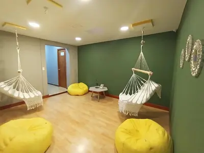 a room with two hammocks in a room at Poblado Park Guest House in Medellín