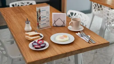 a table with a breakfast of eggs and bread at Poblado Park Guest House in Medellín