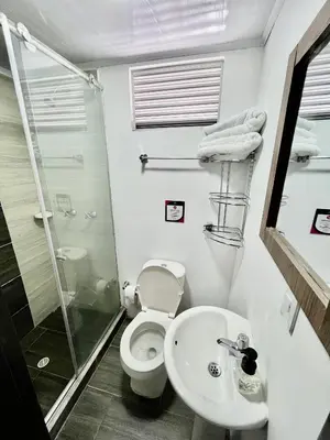 a bathroom with a toilet and a sink and a shower at Amarena Hotel Boutique in Manizales