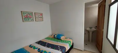 a small bedroom with a bed and a sink at Amplio Apartamento en Los Colores in Medellín