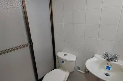 a bathroom with a toilet and a sink at Amplio Apartamento en Los Colores in Medellín