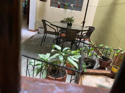 a balcony with a table and chairs and plants at Casa Grande in Medellín