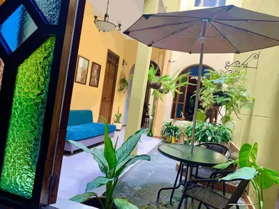 a patio with a table and an umbrella at Casa Grande in Medellín