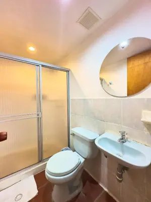 a bathroom with a toilet and a sink and a mirror at Encomendero Hotel -Centro Histórico- in Santa Fe de Antioquia