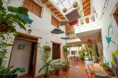 an indoor courtyard with plants and a ceiling at Encomendero Hotel -Centro Histórico- in Santa Fe de Antioquia