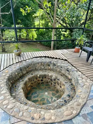 a stone fire pit sitting on a wooden deck at Cabañas San Jose in Doradal