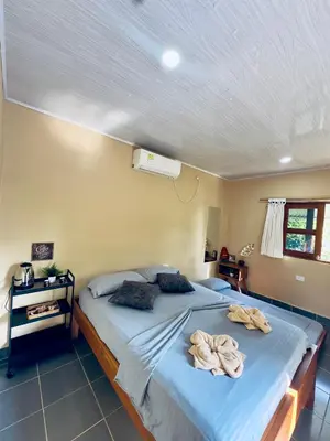 a bedroom with a bed with towels on it at Cabañas San Jose in Doradal