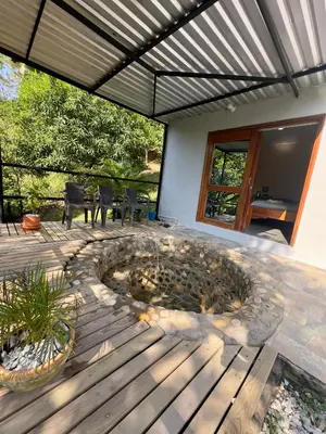 a patio with a fire pit in the middle at Cabañas San Jose in Doradal