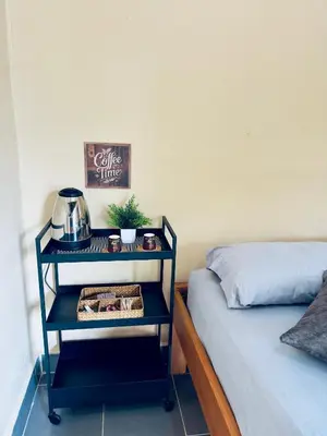 a night stand next to a bed in a room at Cabañas San Jose in Doradal