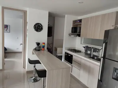 a kitchen with a counter and a refrigerator at Casitadisol in Santa Fe de Antioquia