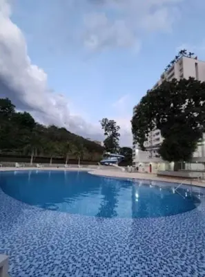 a large blue swimming pool in a building at Casitadisol in Santa Fe de Antioquia