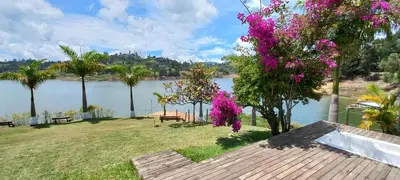 a house with a view of a body of water at Jordan Hotel Boutique in Guatapé