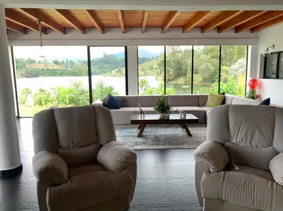 a living room with two chairs and a couch at Jordan Hotel Boutique in Guatapé